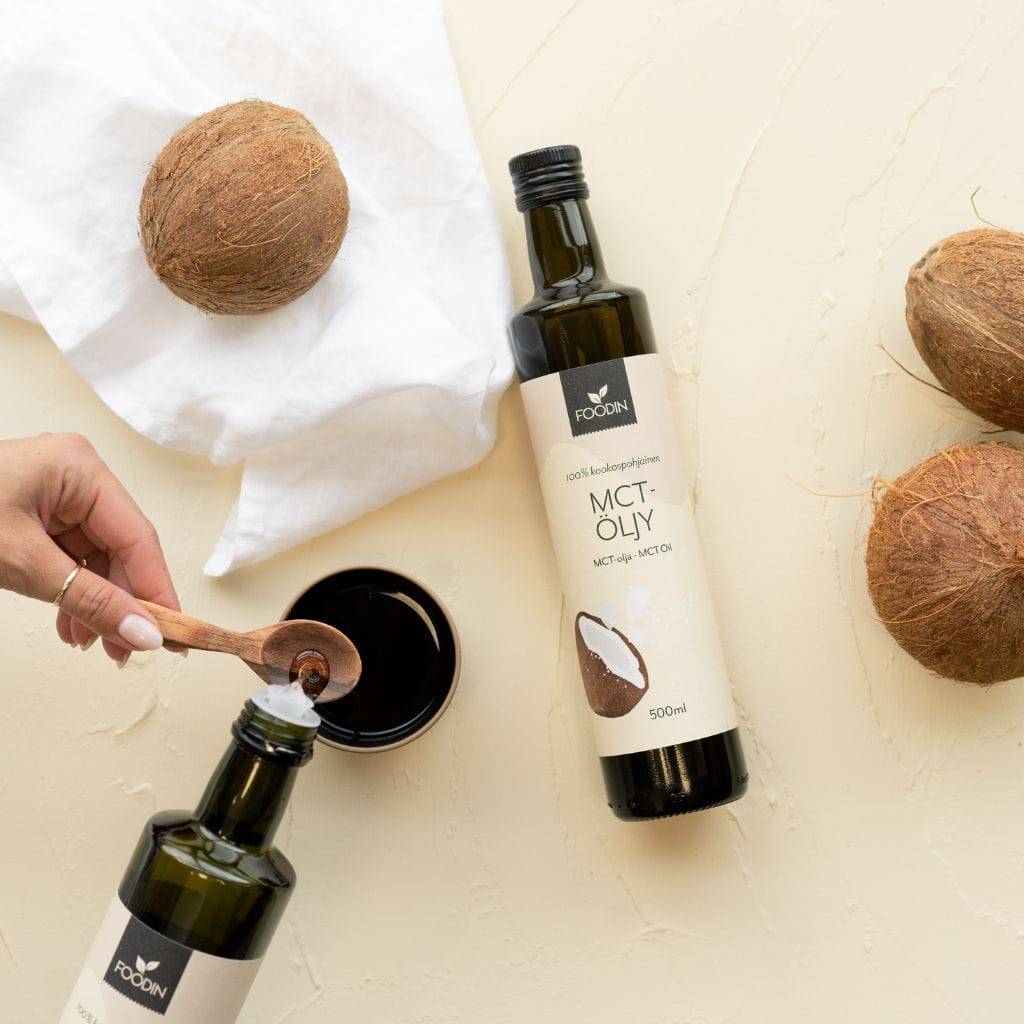 Organic MCT coconut oil in a 500ml bottle from Organax Ltd, showing clear glass bottle filled with golden coconut oil.