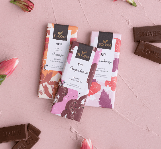Organic raw chocolate with hazelnuts, Foodin Crunchu 54%, in a 40g bar from Organax Ltd, showing the chocolate and hazelnuts.