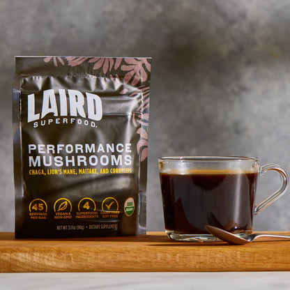 Organic Performance Mushrooms from LAIRD by Organax Ltd, 90g package, fresh and sliced mushrooms on a white background.