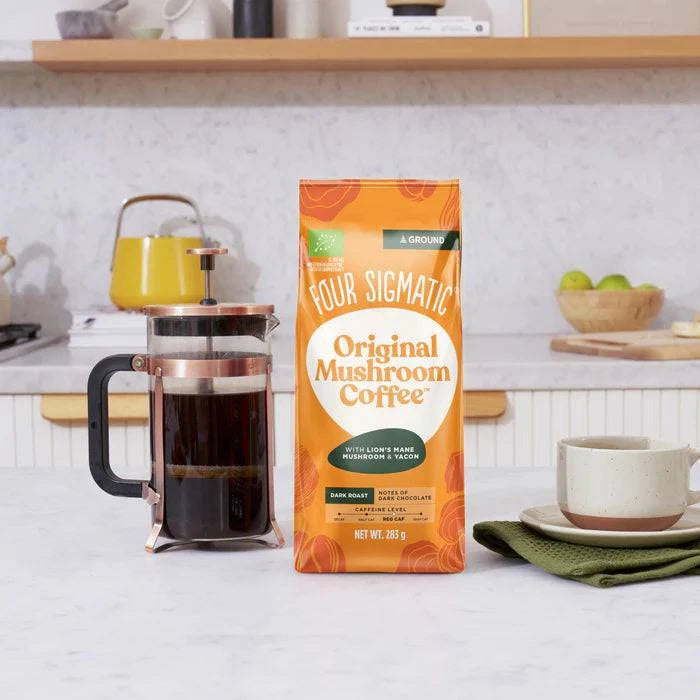 Dark roast ground coffee with Lion's Mane mushroom from Four Sigmatic, shown in a lifestyle setting in the image.