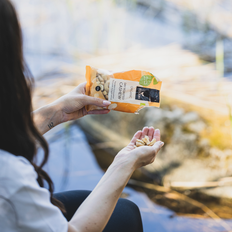 Organic FoodIn Dry Roasted Cashews in 140g package, showing golden roasted cashew nuts in a clear view.
