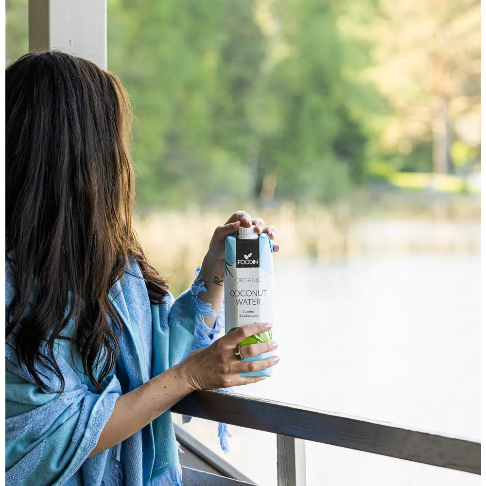 Organic Foodin Coconut Water with Electrolytes in a 1-liter bottle, showing fresh coconut water from Foodin brand.
