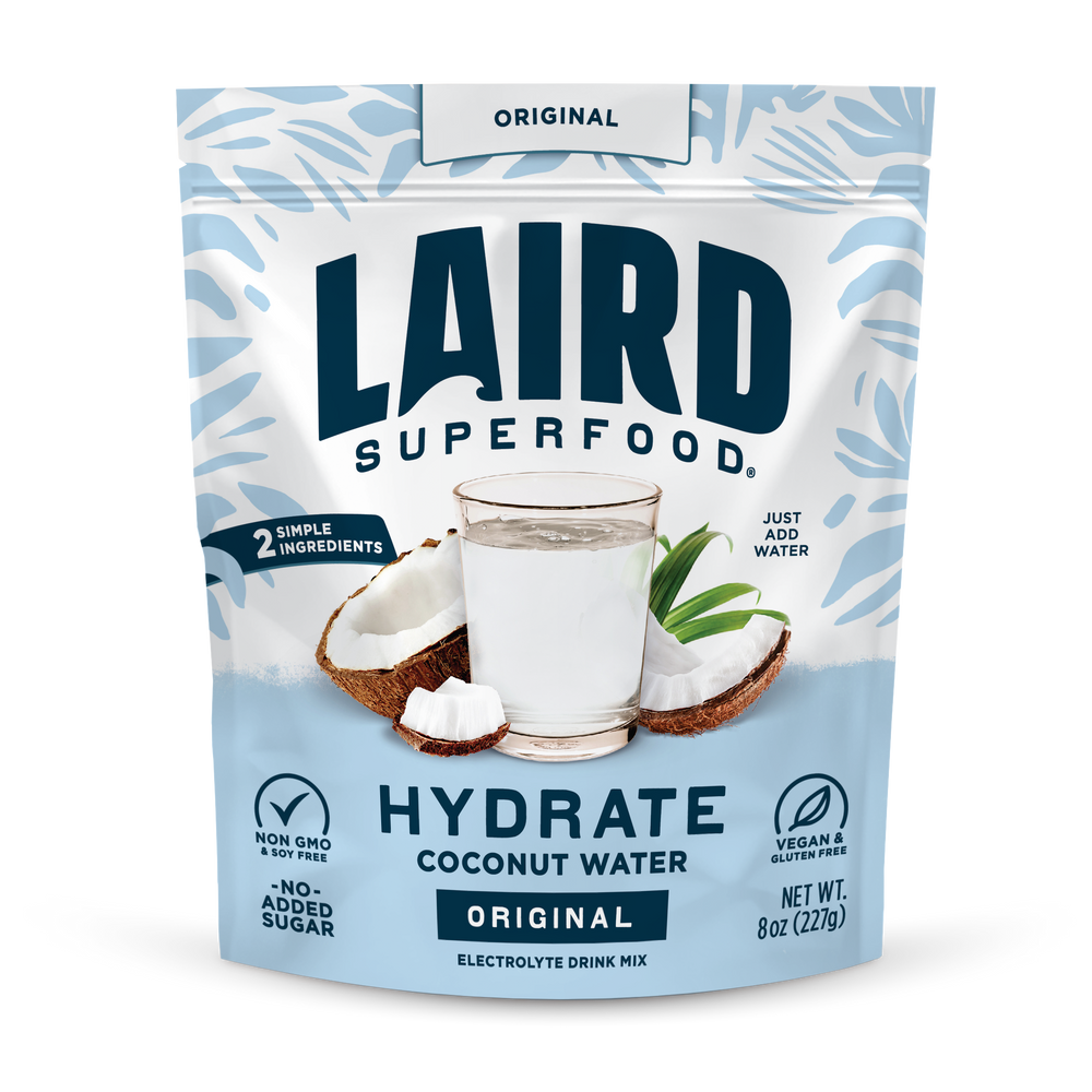 Laird Hydrate Coconut Water in a 227g pouch with fresh coconut imagery, showcasing a natural and hydrating beverage by Organax Ltd.