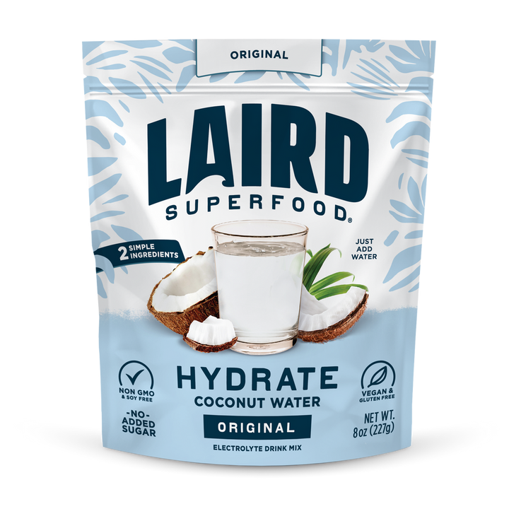 Laird Hydrate Coconut Water in a 227g pouch with fresh coconut imagery, showcasing a natural and hydrating beverage by Organax Ltd.