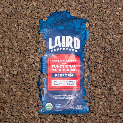 Dark roast ground mushroom coffee by Organax Ltd, Laird Organic PERFORM Functional Mushroom Coffee, 340g jar with coffee grounds inside.