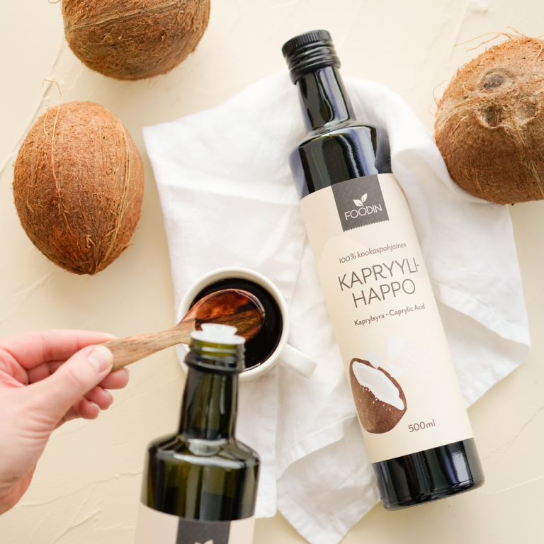 Organic Caprylic Acid from coconut in a 500ml bottle, produced by Organax Ltd, shown in a clear plastic container.