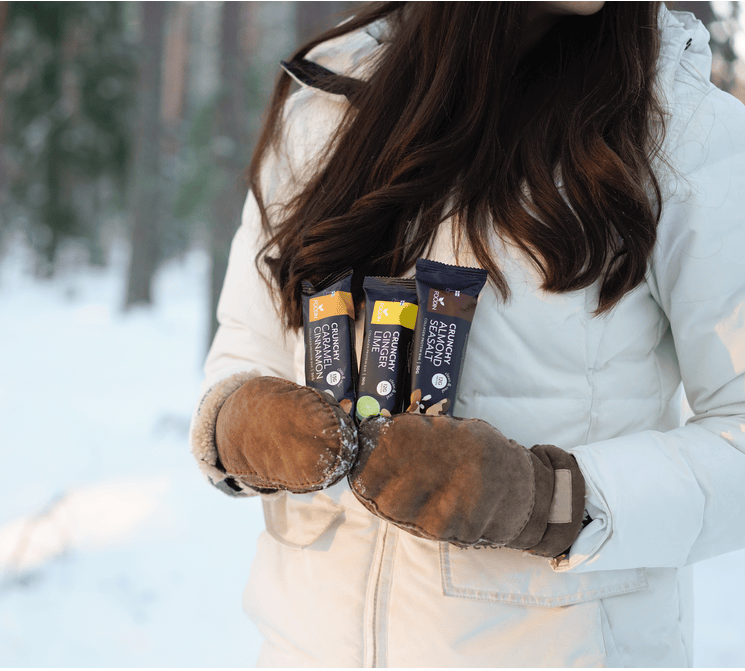 Organic Collagen Protein Bar in caramel cinnamon flavor with nut and seed pieces, 50g each, shown in packaging.