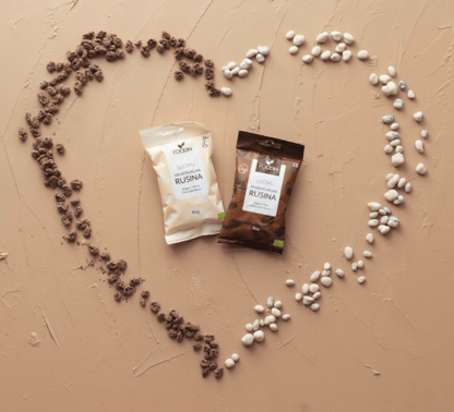 Organic white chocolate raisin snack by Organax Ltd, showing a close-up of the white chocolate-coated raisins in a clear container.