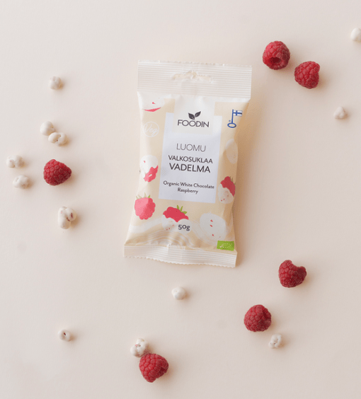 Organic white chocolate with raspberry from FoodIn by Organax Ltd, shown in 50g package with white chocolate and raspberry pieces.