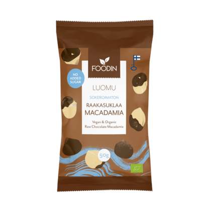 Organic raw chocolate with macadamia nuts in a 50g bar by Organax Ltd, featuring no added sugar and a rich, natural appearance.