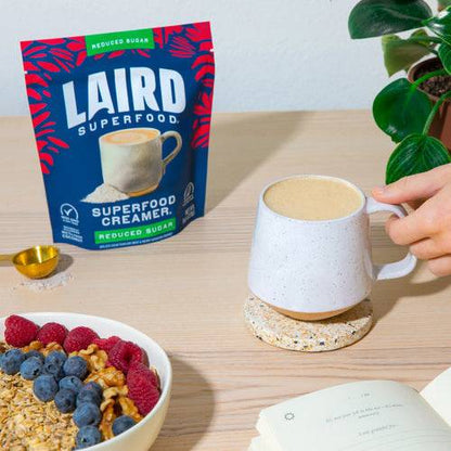 Laird Reduced Sugar Superfood Creamer by Organax Ltd in 227g jar, showing the creamy textured product with label.