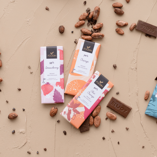 Organic Raw Chocolate Peppermint 70% bar by Organax Ltd, showing a close-up of dark chocolate with peppermint pieces.