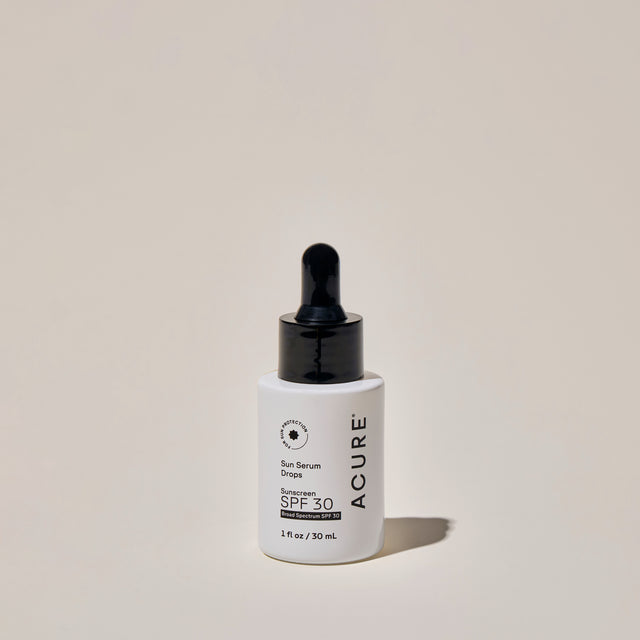 ACURE Sun Serum Drops SPF 30 in a 30ml bottle, featuring clear liquid with dropper applicator for sun protection and skincare.