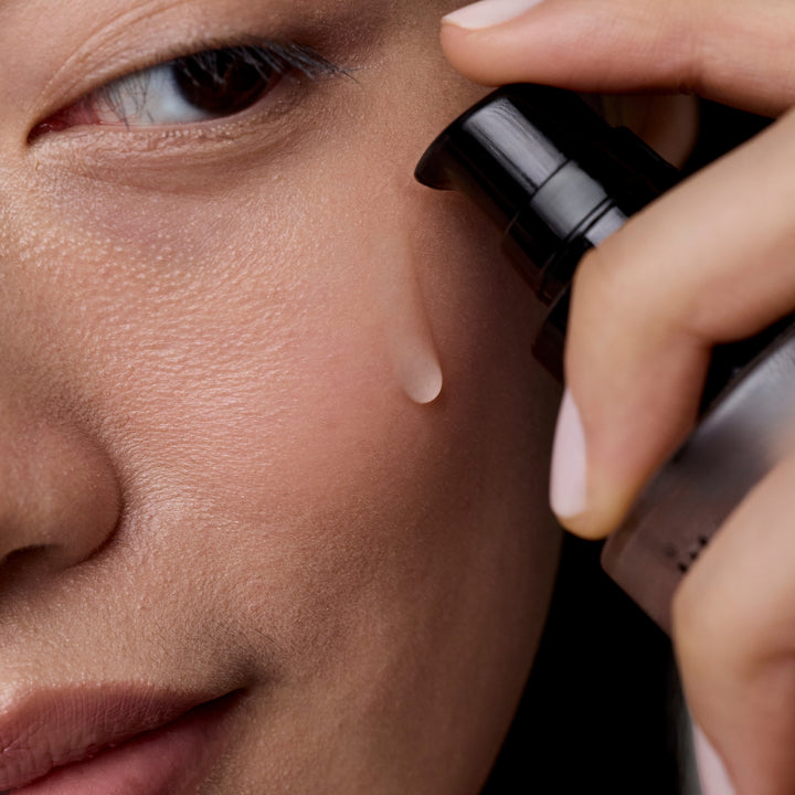 Application of ACure The Super Drench Serum by Organax Ltd, showing the skincare product being gently applied to skin.