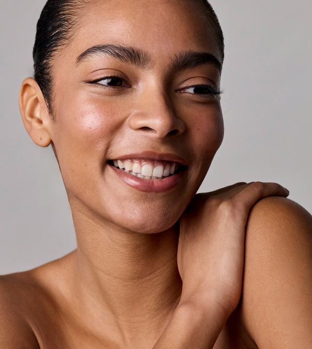 Acure Skin Longevity Night Trio skincare set with clean surface and product bottles, on a neutral background.