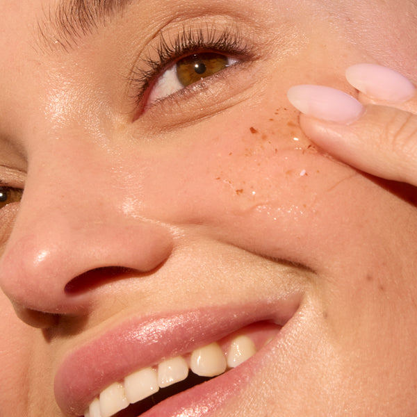 Applying ACURE Zombie Cell Clarifying Mask in a 40ML container, showing the mask being spread on the face for skin clarity.